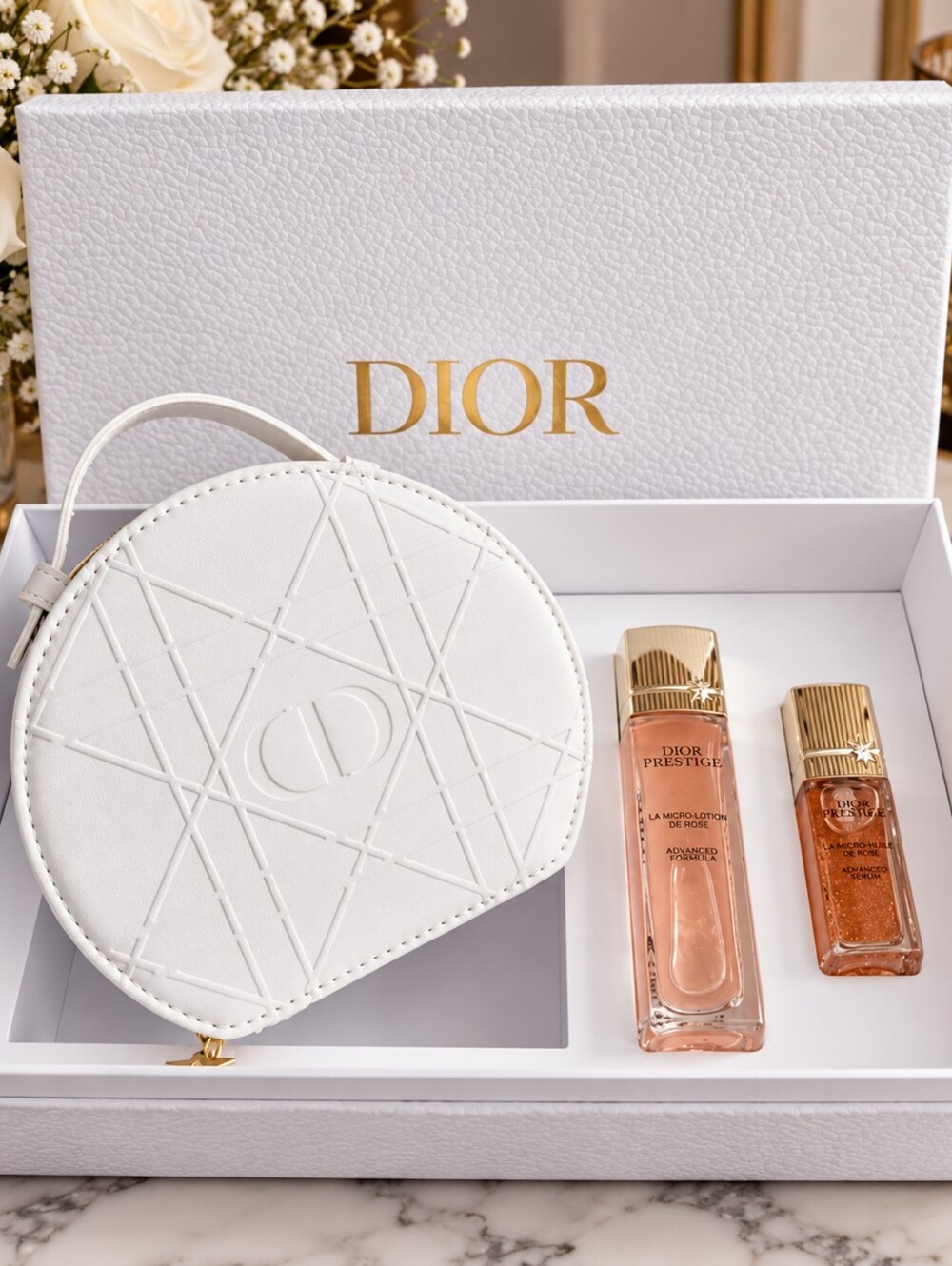 Dior vanity case pouch with top handle and Dior Prestige skincare Kit.